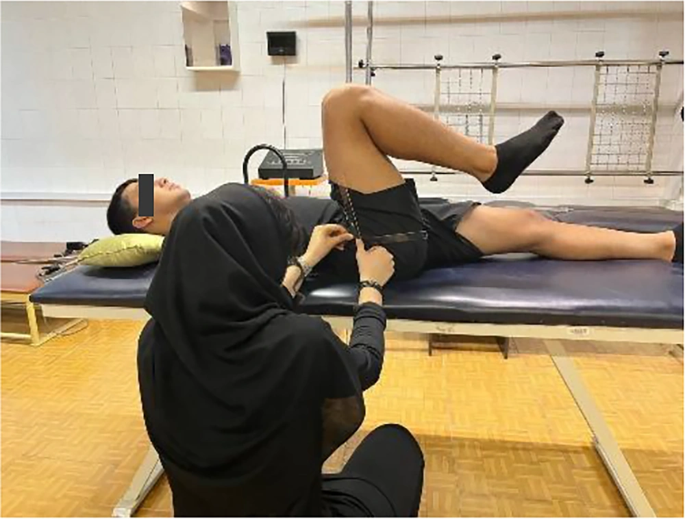 Hip flexion measurement: Supine participant with goniometer positioned at greater trochanter, stationary arm on pelvis, and moving arm along femur. Hip flexion measurement: Supine participant with goniometer positioned at greater trochanter, stationary arm on pelvis, and moving arm along femur.