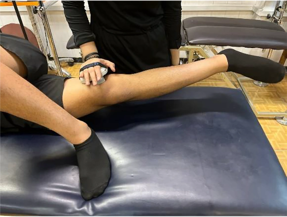 Dynamometric assessment of isometric hip adductor strength in side-lying position, with device positioned above medial femoral epicondyle Dynamometric assessment of isometric hip adductor strength in side-lying position, with device positioned above medial femoral epicondyle