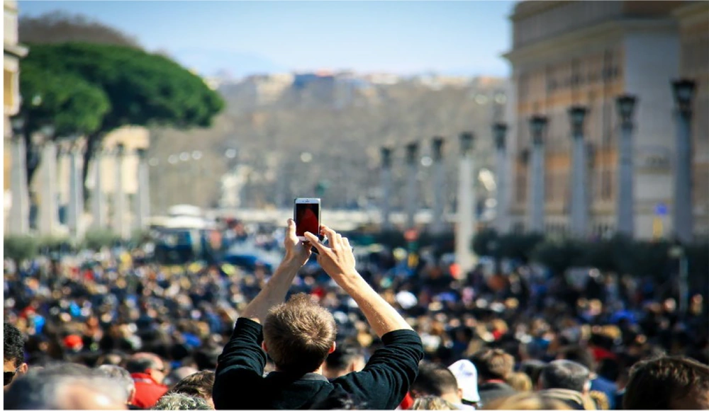 A Participant at a mass gathering using a smartphone to capture and share the event (<a href="#A161865REF11">11</a>) A Participant at a mass gathering using a smartphone to capture and share the event (<a href="#A161865REF11">11</a>)